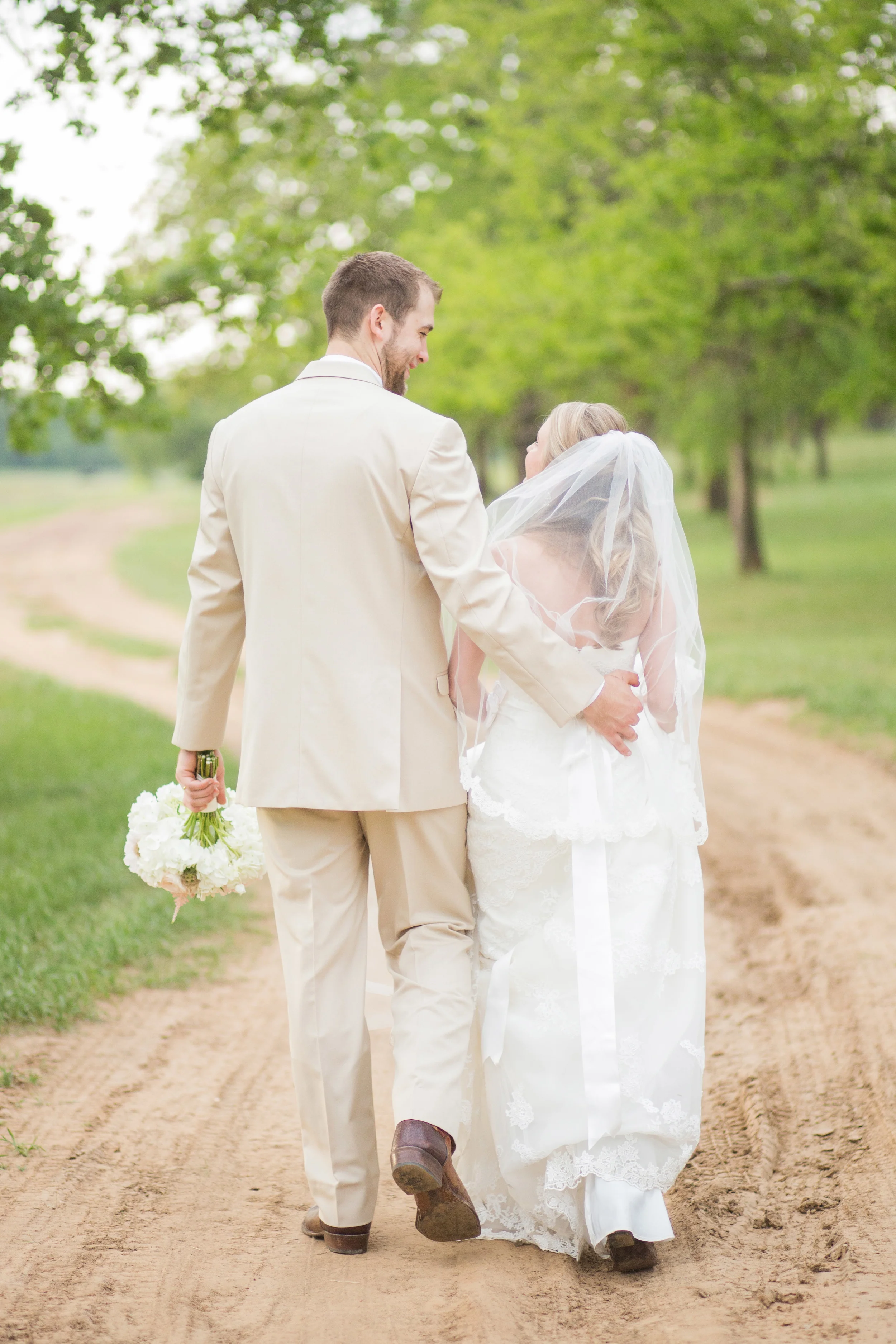 Bride & Groom walking down path