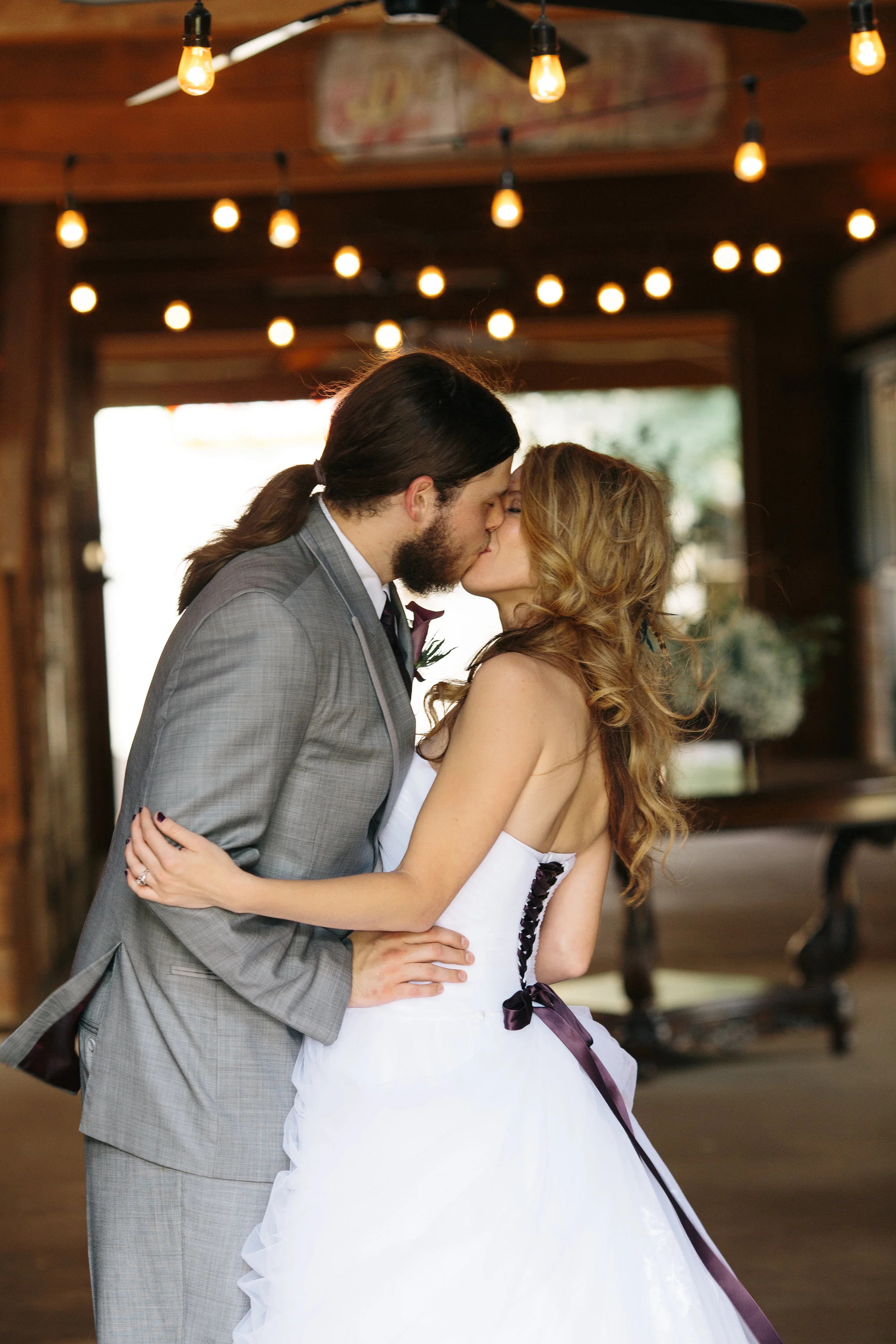 Bride & Groom Kissing in Barn