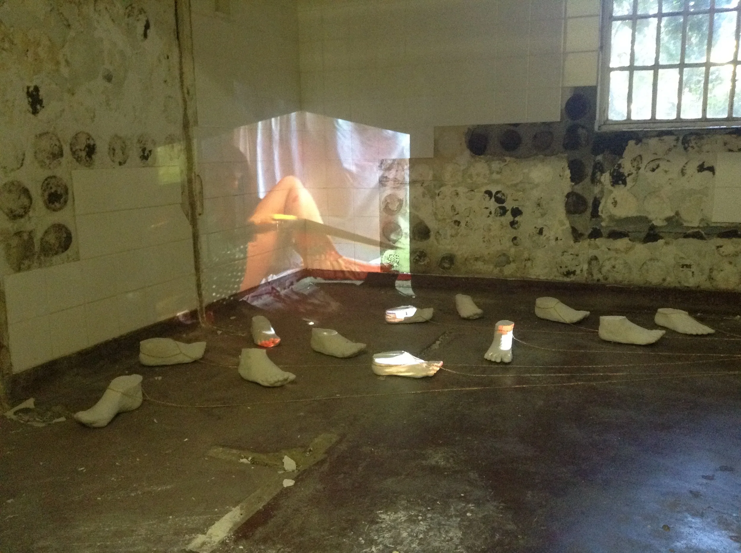  'I Have To Save My Family', Cast feet, gold chain, video projection 