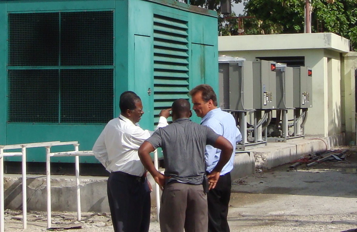 (AAN) Autorite Aeroportuaire Nationale Director General (Haiti) Lionel Isaac (far left) reviewing airport power plan repairs and 3 MW solar field design & placement for the Port Au Prince Airport