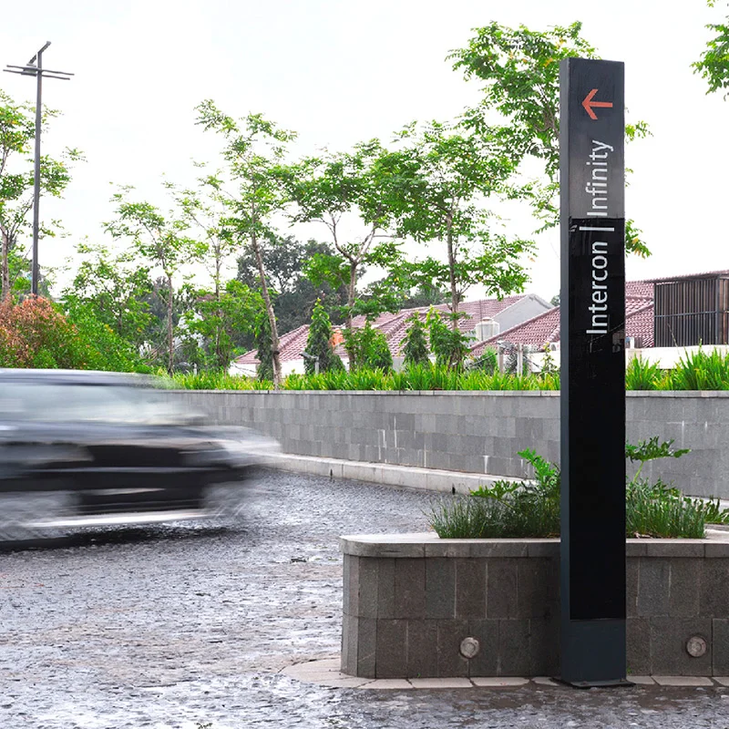 Backlit vehicular directional signage constructed of PU coated steel and back painted glass.