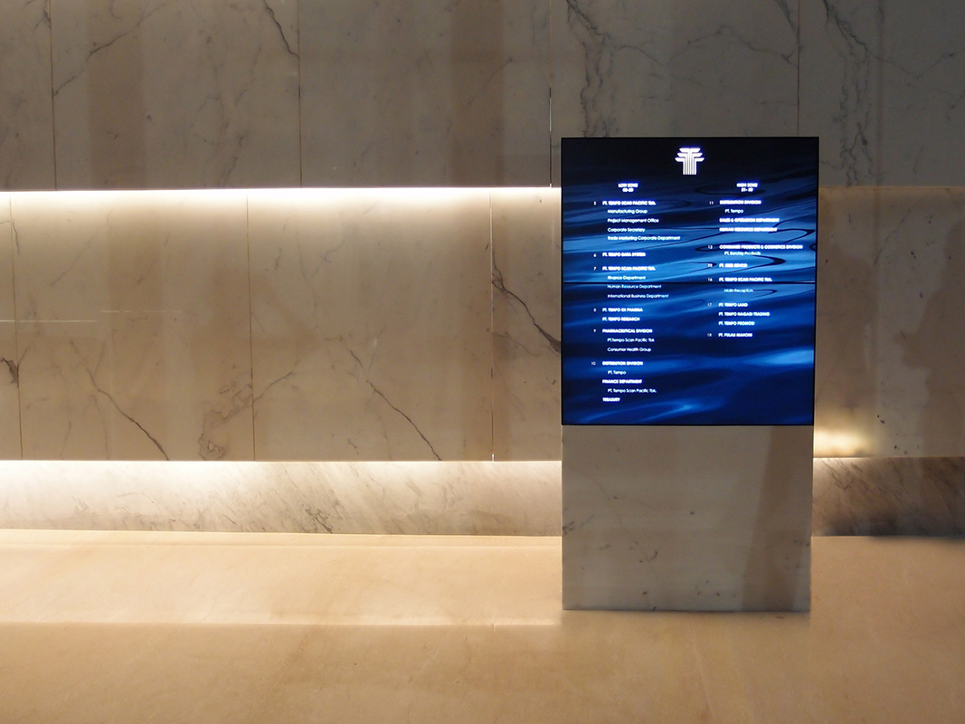 The client opted for a non-interactive, but dynamic tenant directory, making use of two thin bezelled video screens.