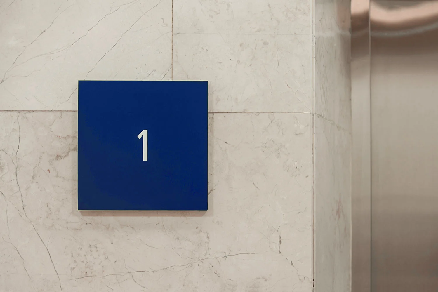 Floor number indicators in matte dark blue on 10mm acrylic.
