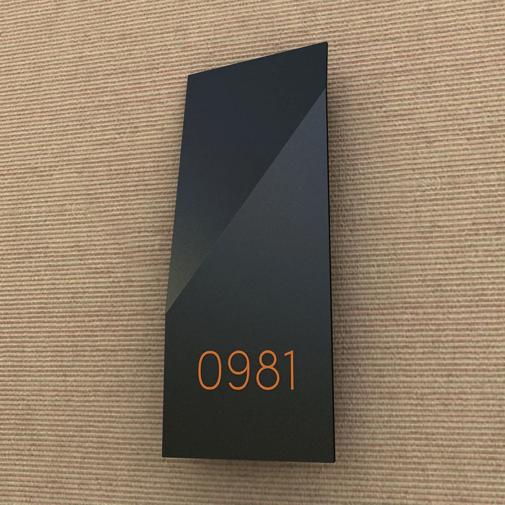 Room number with slanted fold shape. Black matte painted stainless steel finishing.