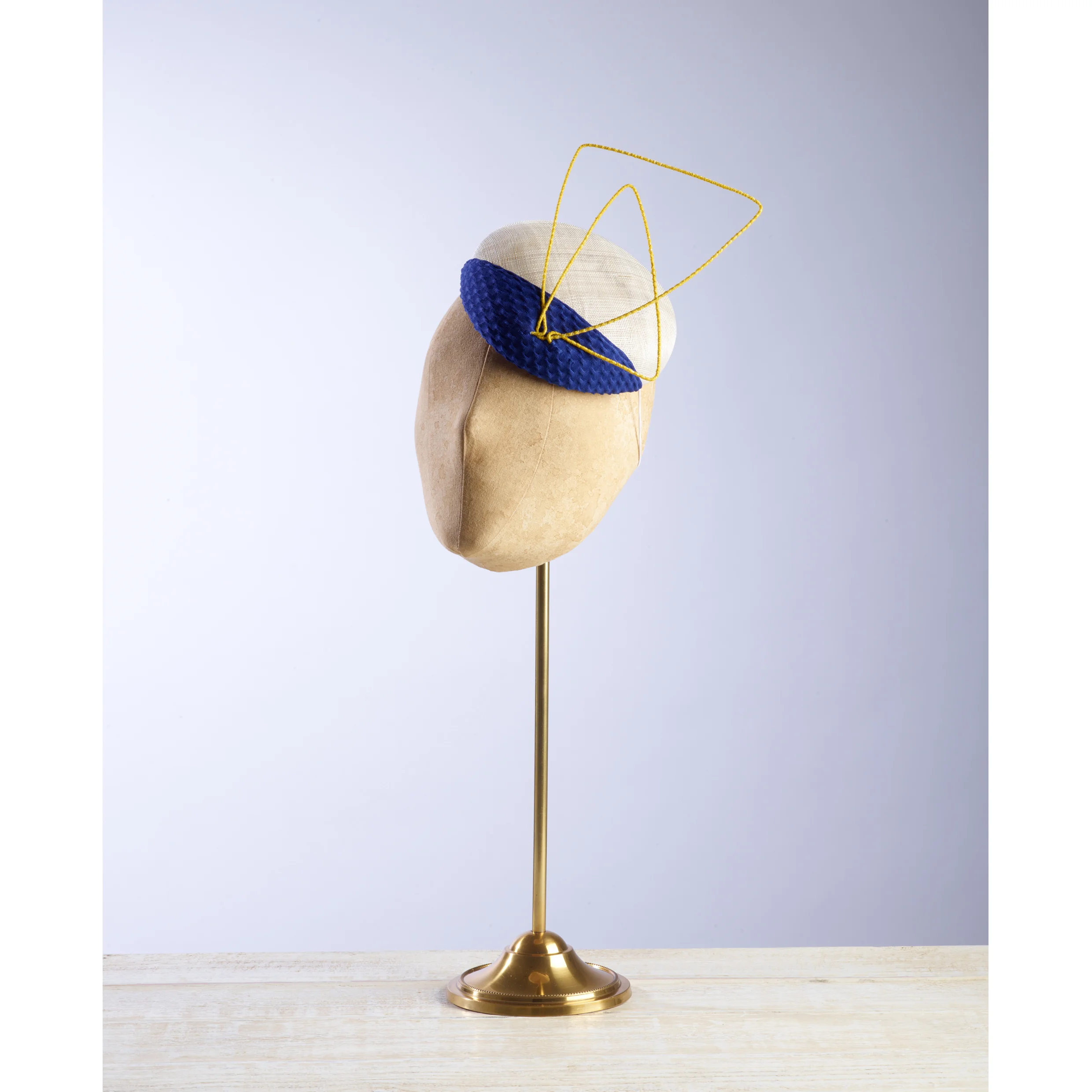 CANTILEVER - £65 Cream pinokpok button with contrasting royal blue fabric and abstract yellow wire.