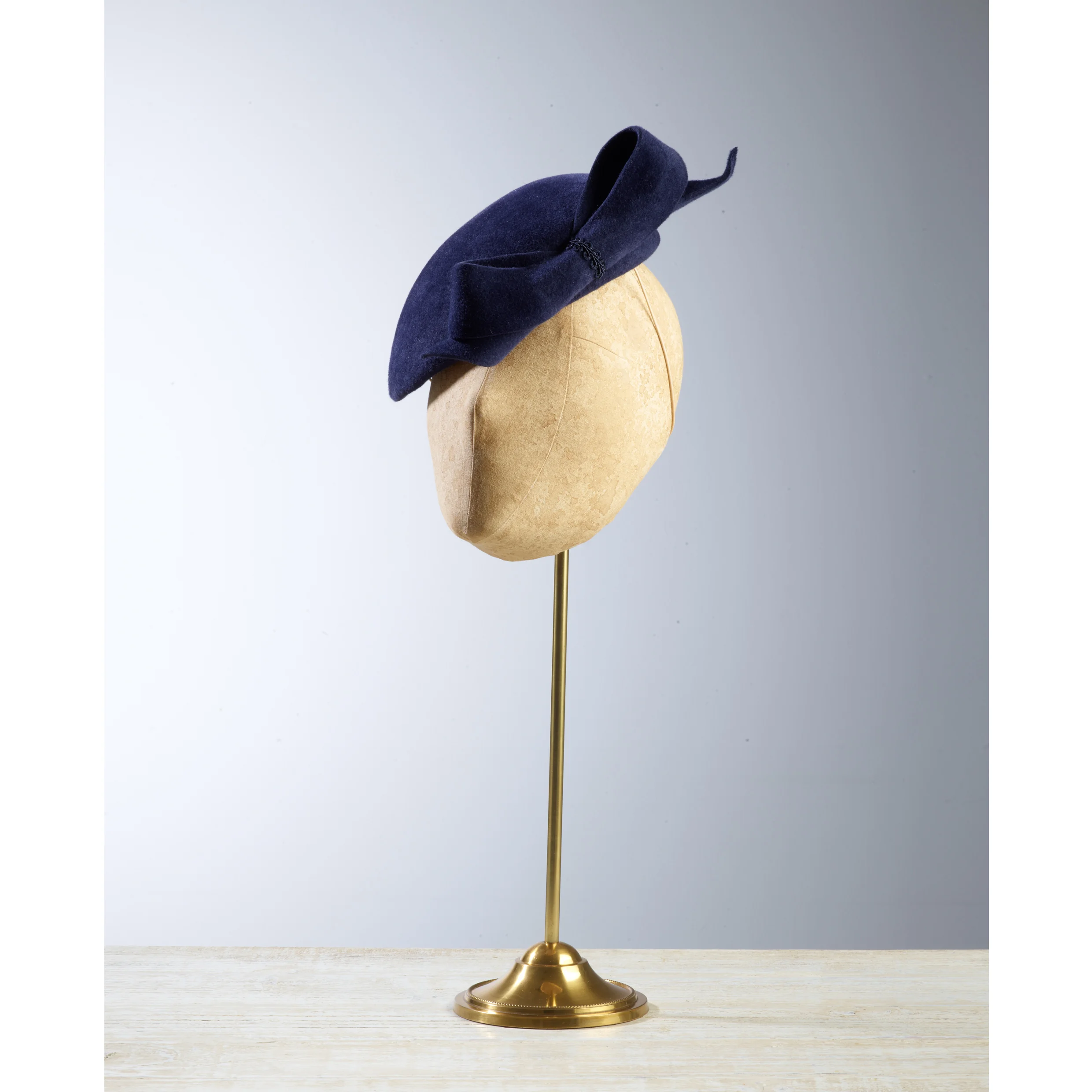 DART - £75 Navy peachbloom felt oval headpiece, finished with bow on front.