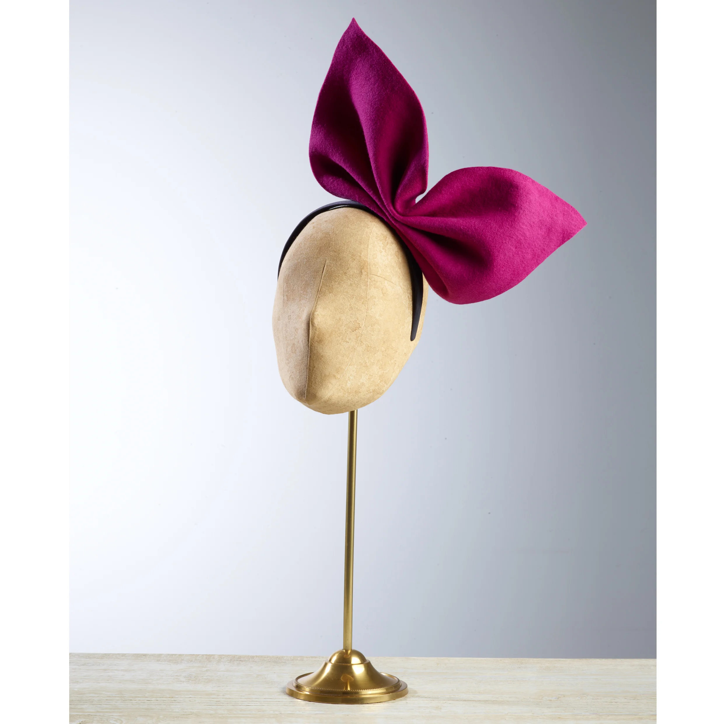 PAGODA - £60 Pink wool felt bow fixed onto a black hairband.