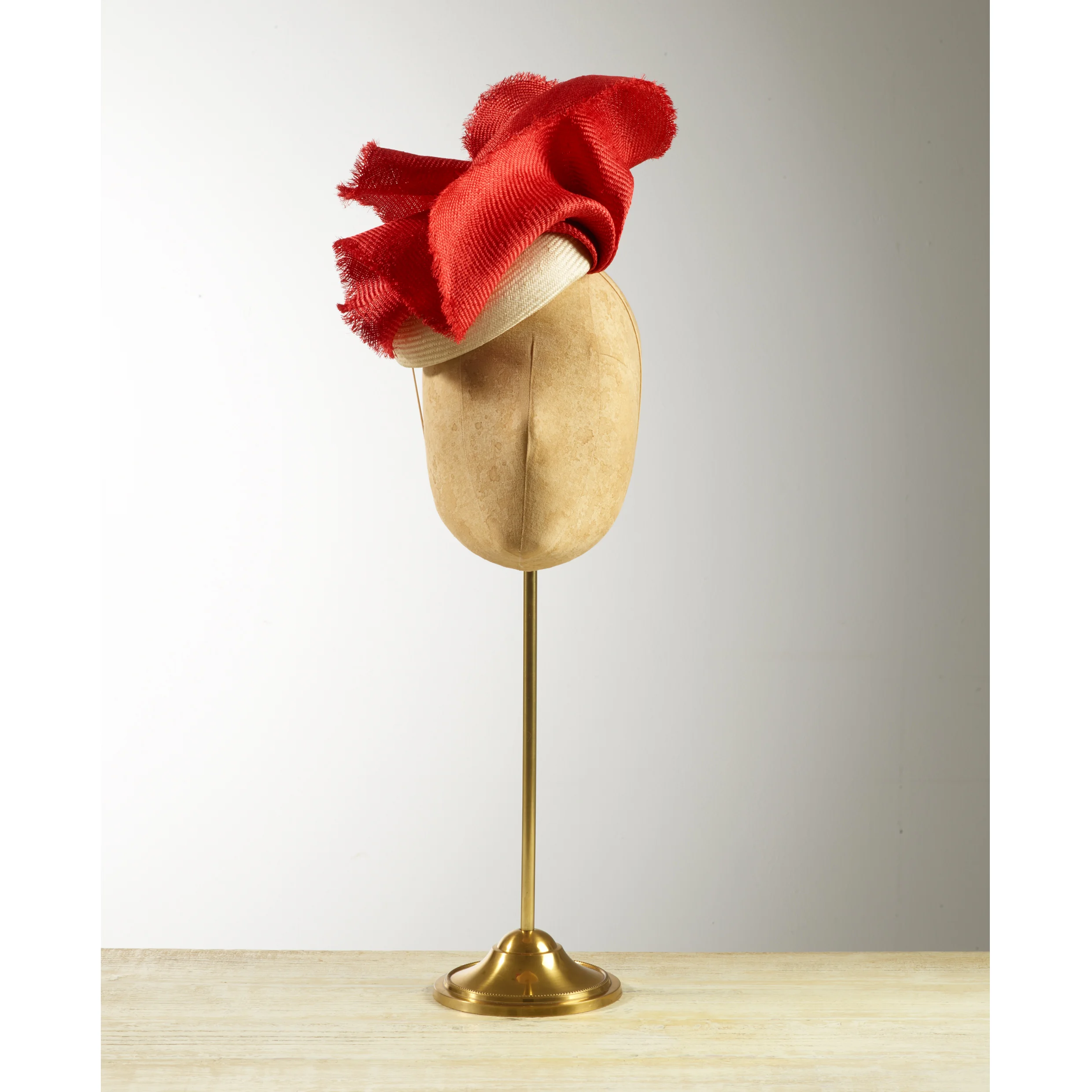 CACTI - £80 Cream sisal straw button headpiece with frayed edge red structural folds.
