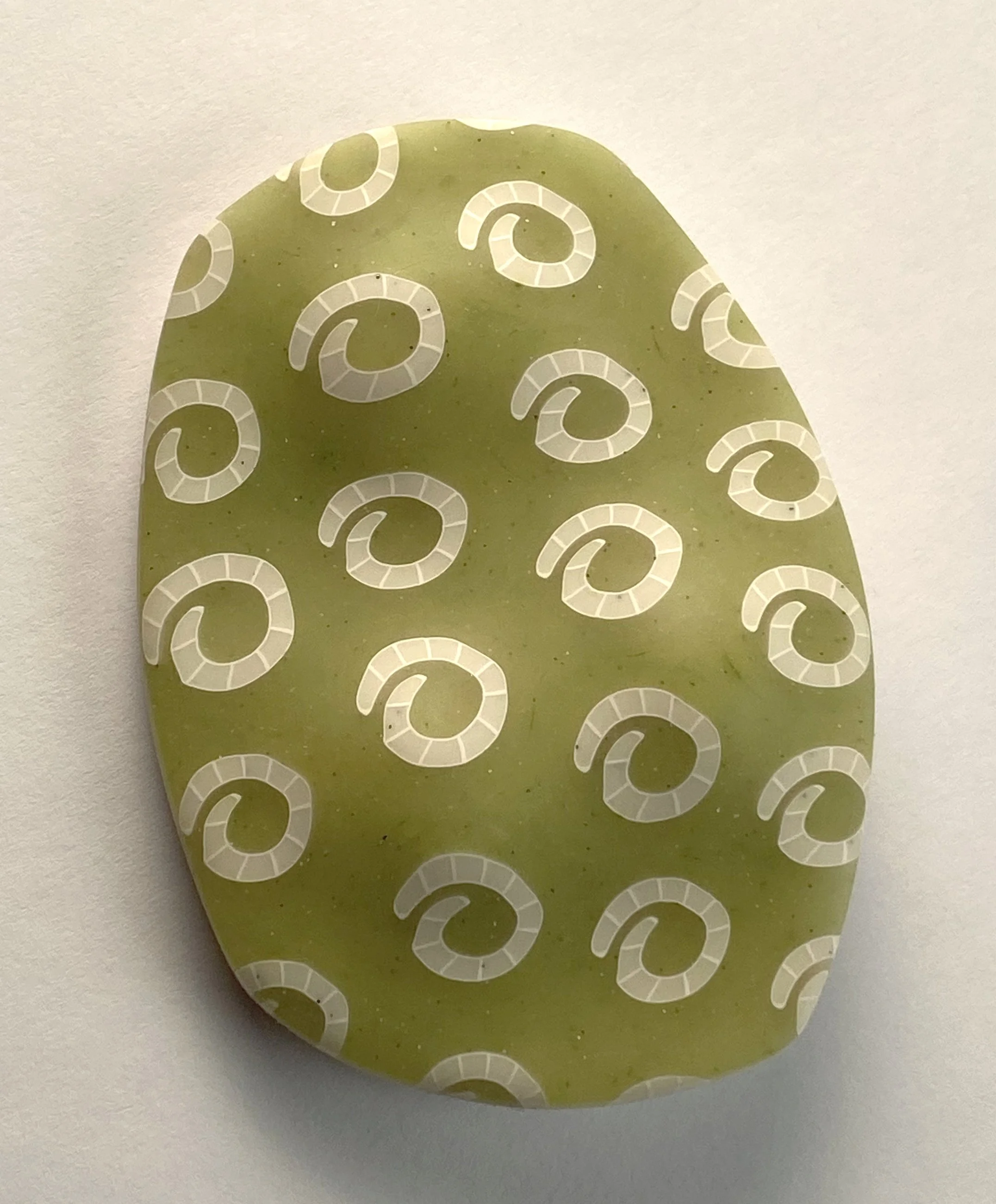 Three hidden pebbles brooch in green white spirals.jpg
