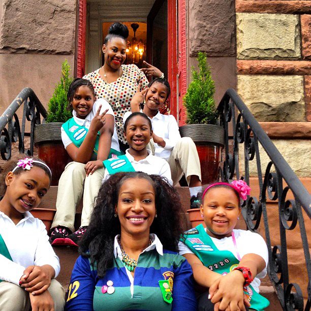 Emicia poses with her Girl Scouts.