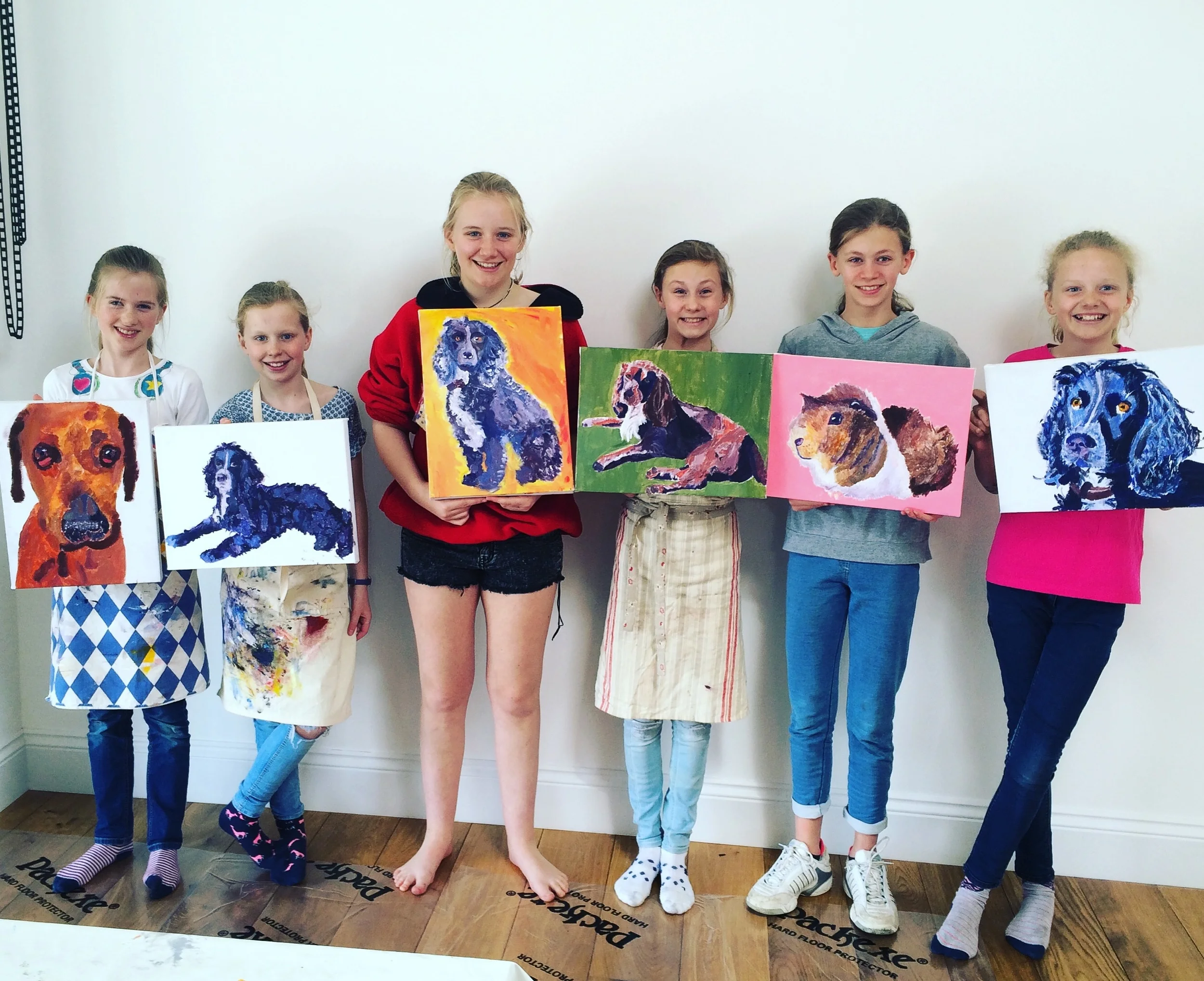 Quince Art School students with paintings of their pets