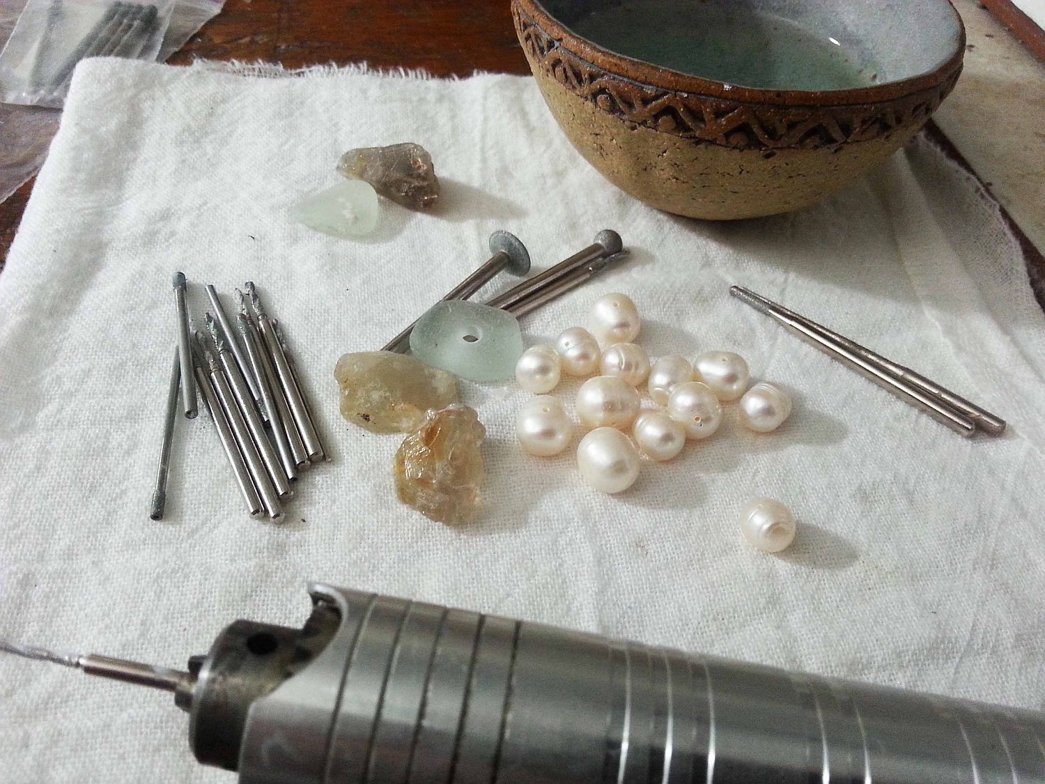 next came drilling larger holes into the pearls, gems and sea glass