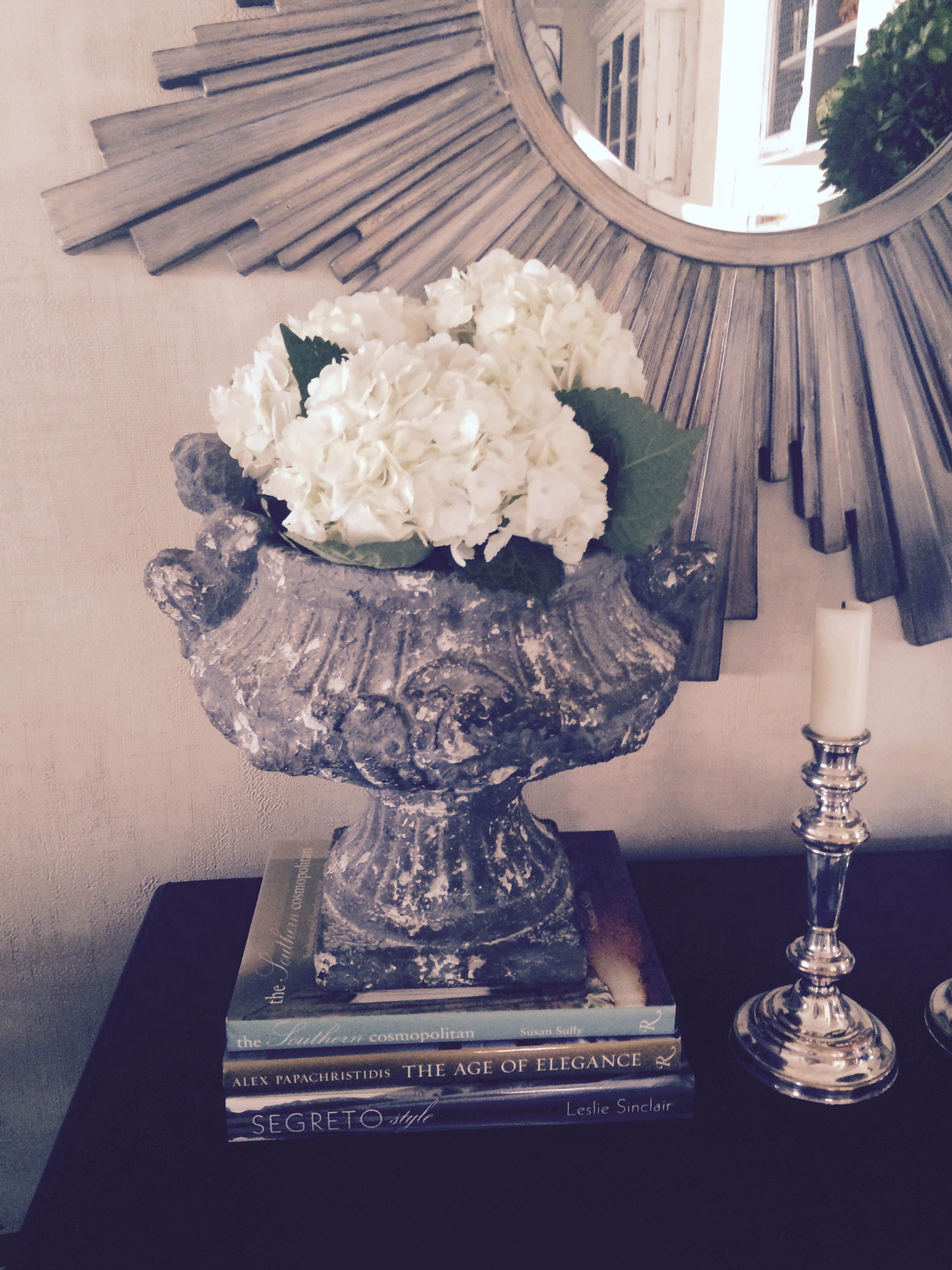 Fresh hydrangeas look great in an urn in our designer Cathy's living room. She placed the hydrangeas in a mason jar and tucked the mason jar inside the urn, viola! 