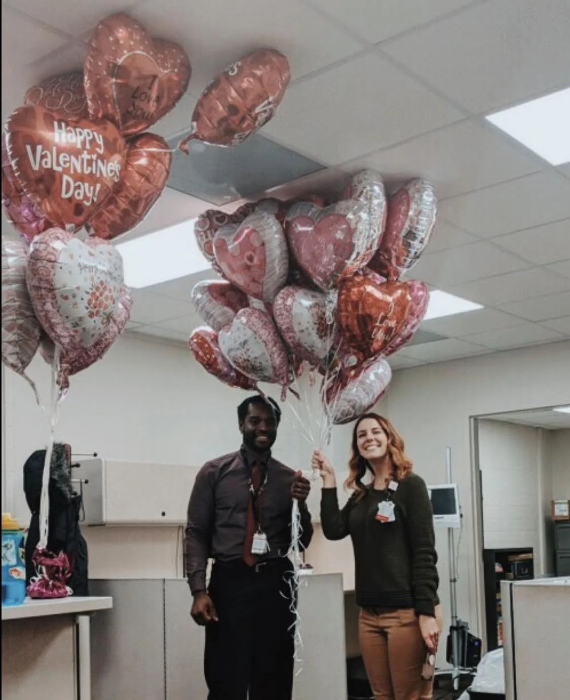 Taylor and a coworker getting some ballons ready to give to patients for Heart Awareness month.