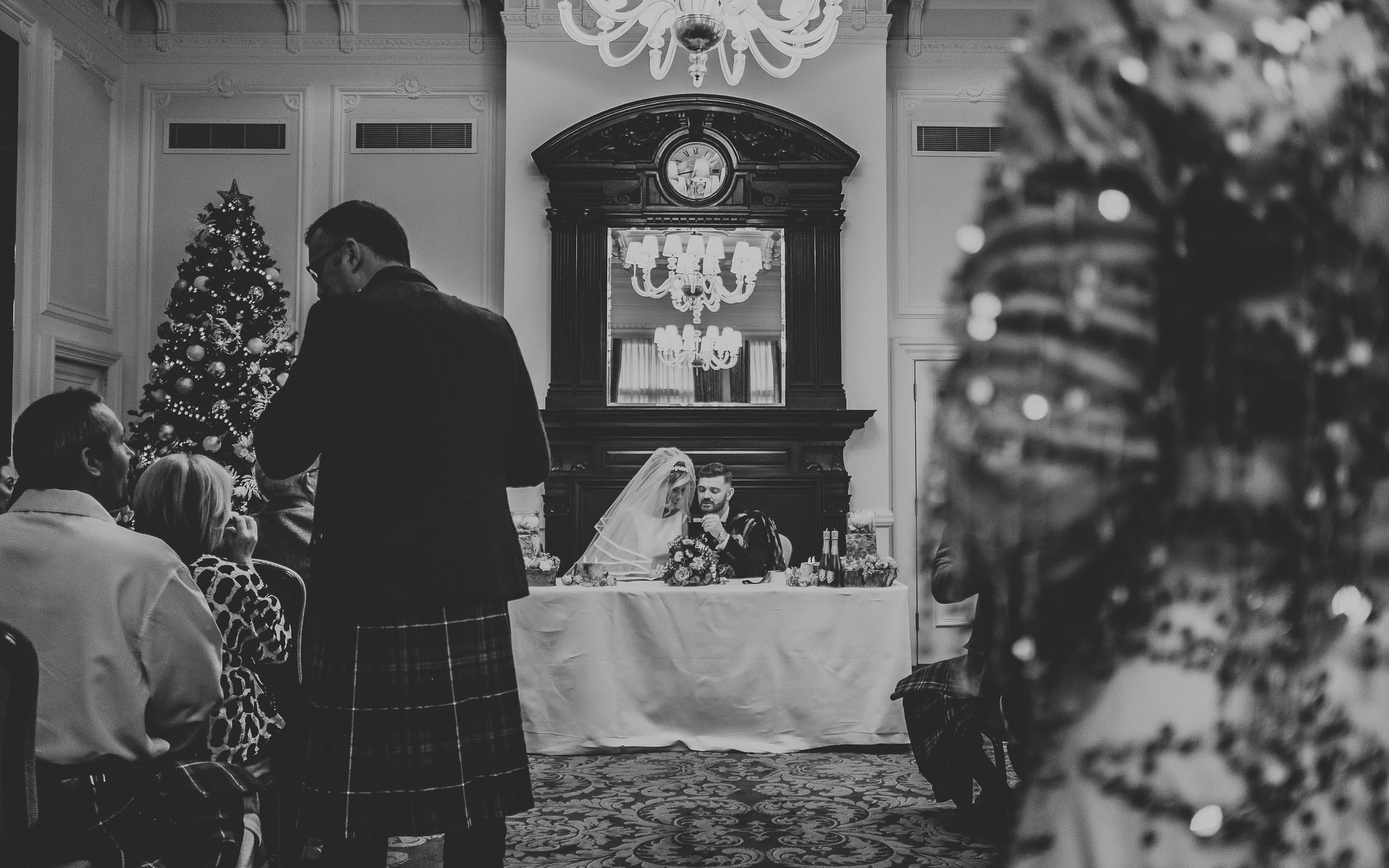 Bride and groom signing their wedding marriage register after tying the know in Liverpool city centre