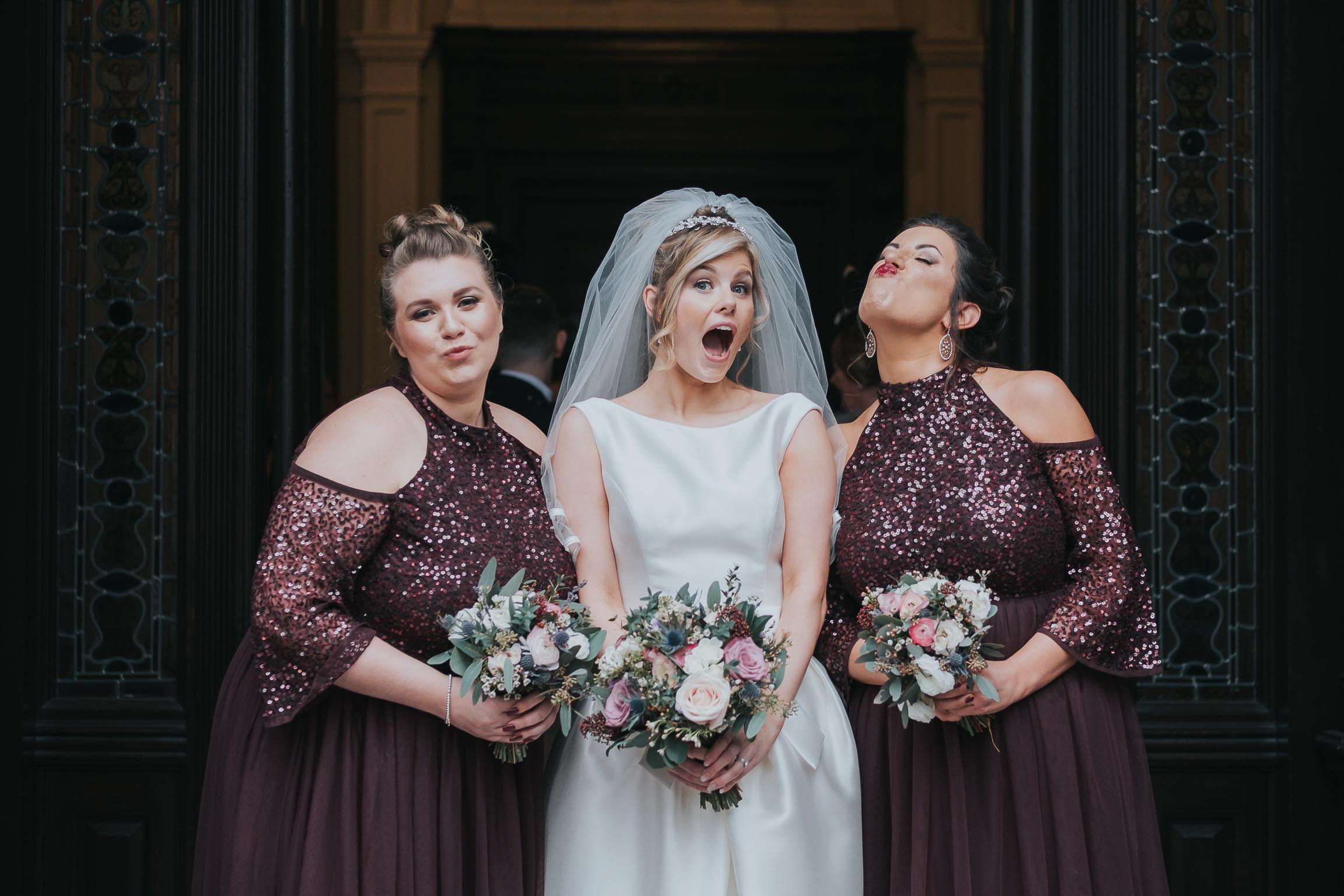 the bride and bridesmaids during their wedding day making funny faces