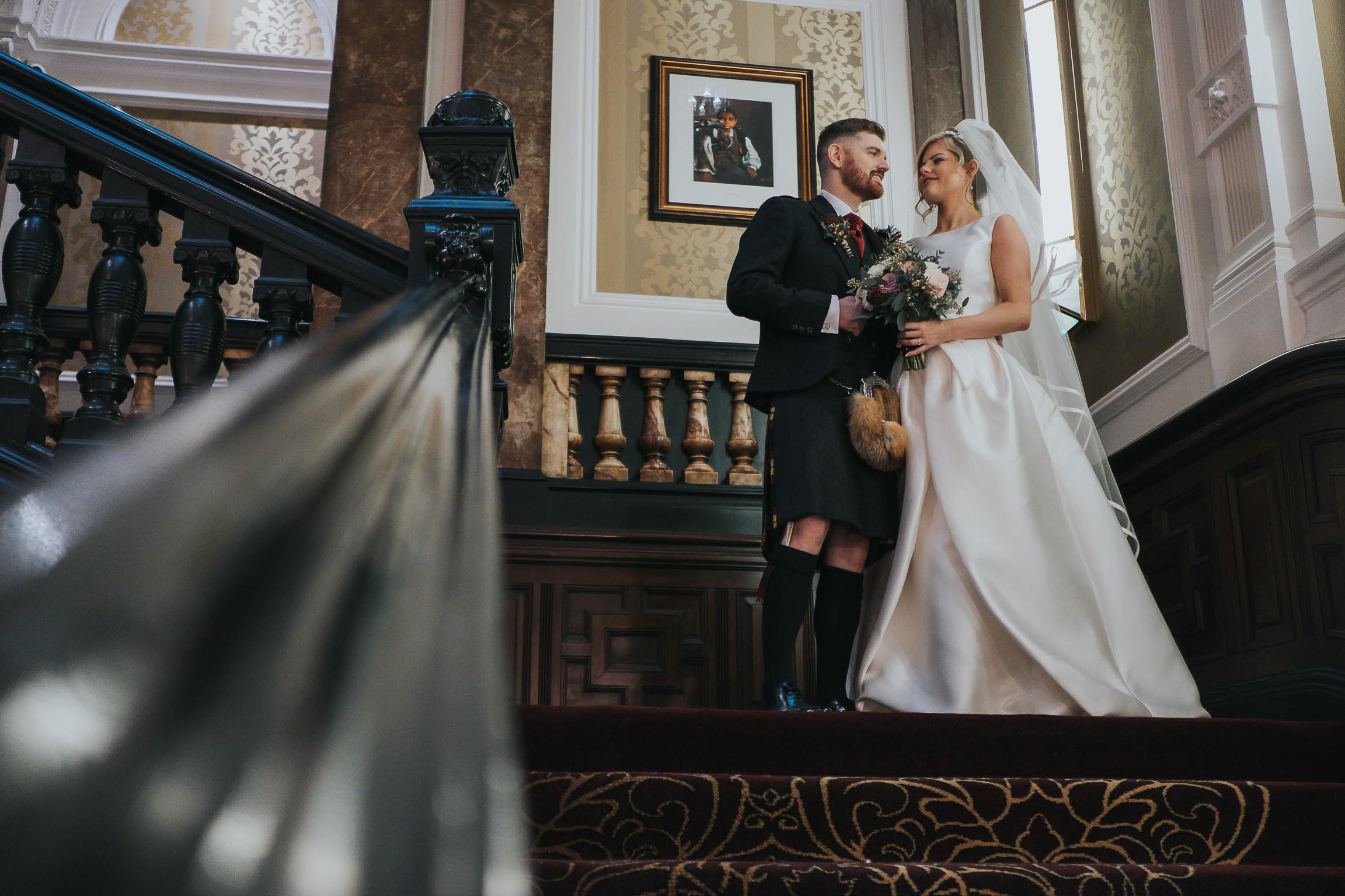 bride and groom stood on the staircase at the Double Tree in Liverpool