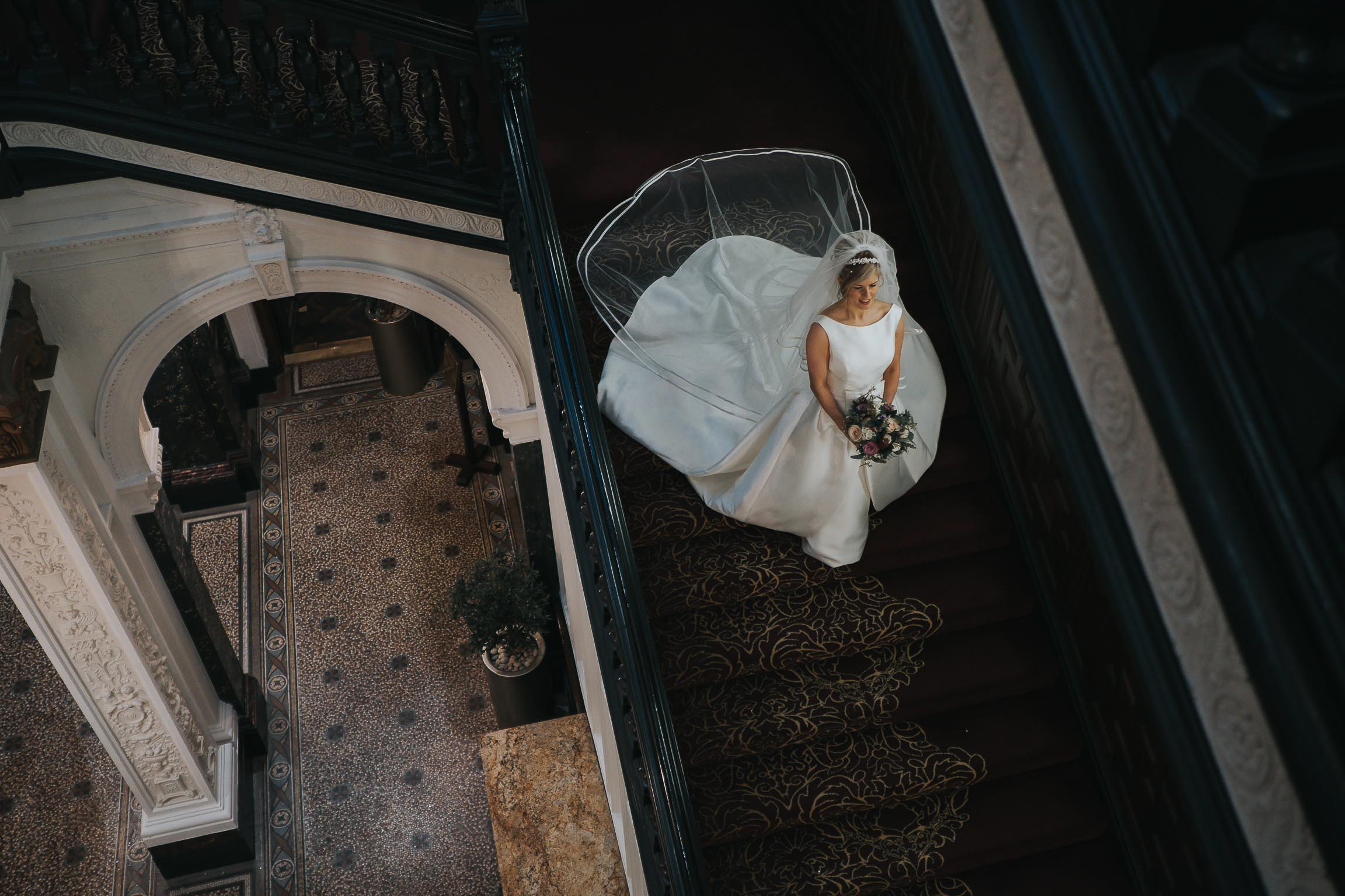 stunning bride in her wedding dress on the stairs in Liverpool