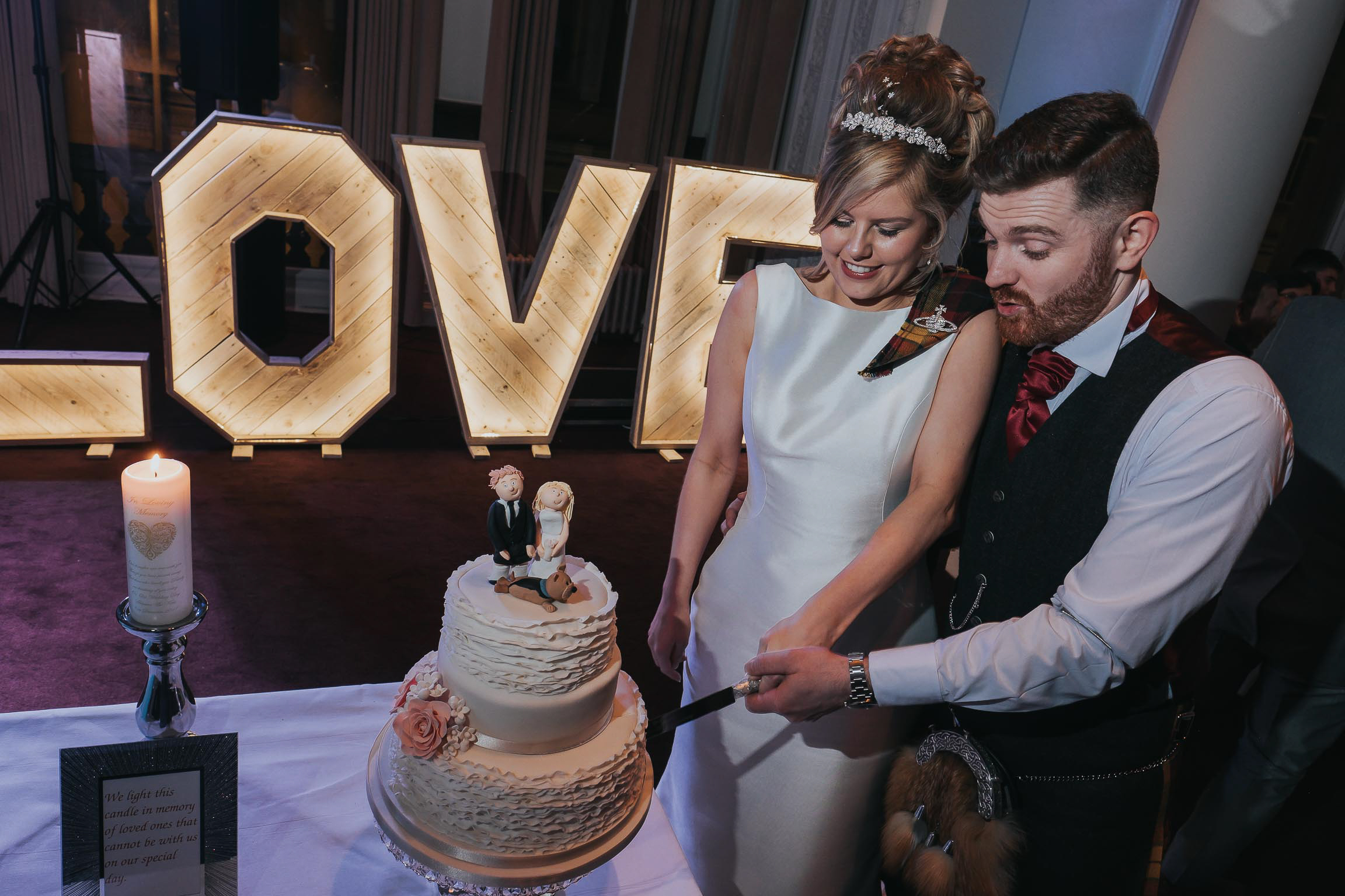 bride and groom cutting their wedding cake on their wedding day