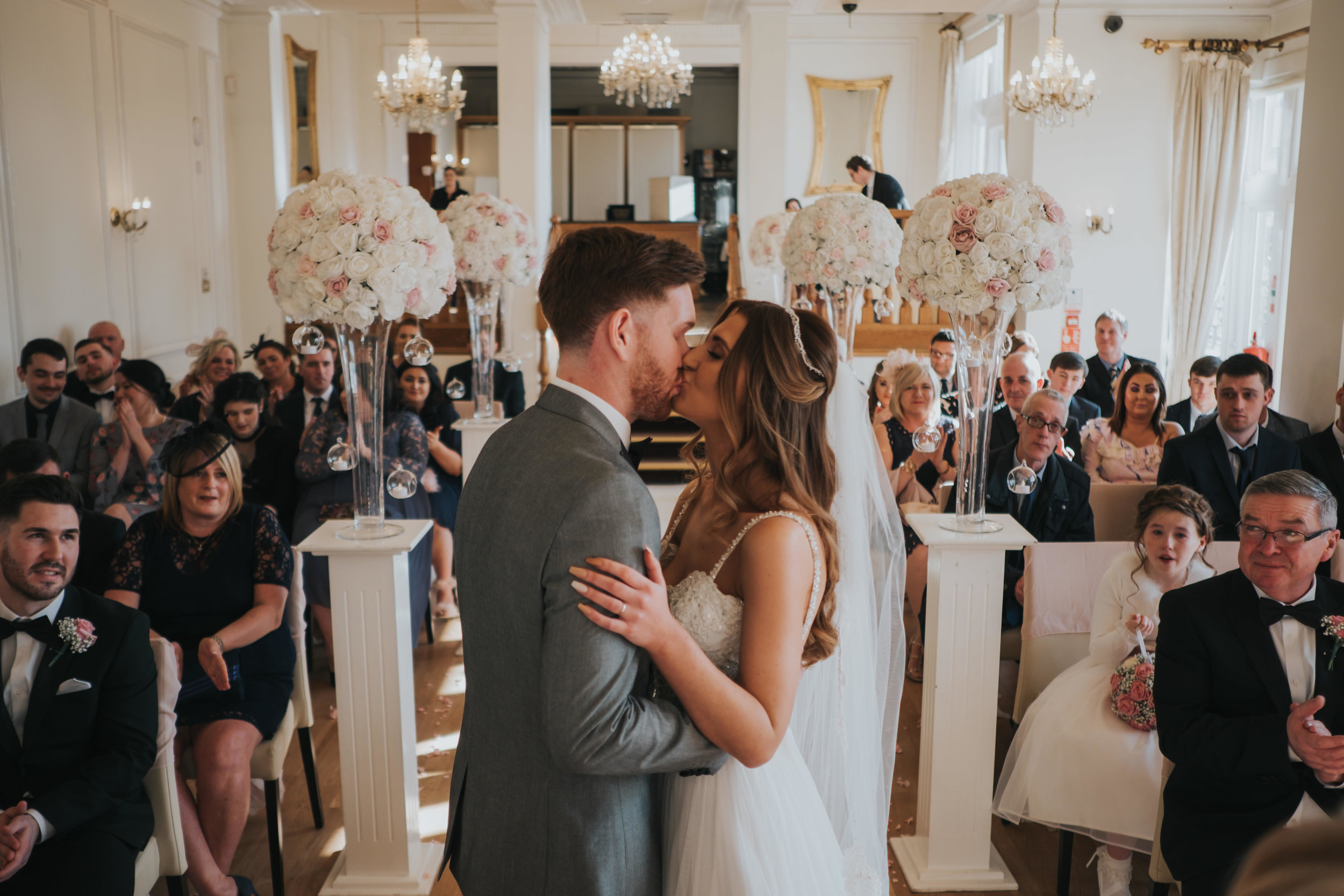 the first kiss from the bride and groom during their wedding ceremony