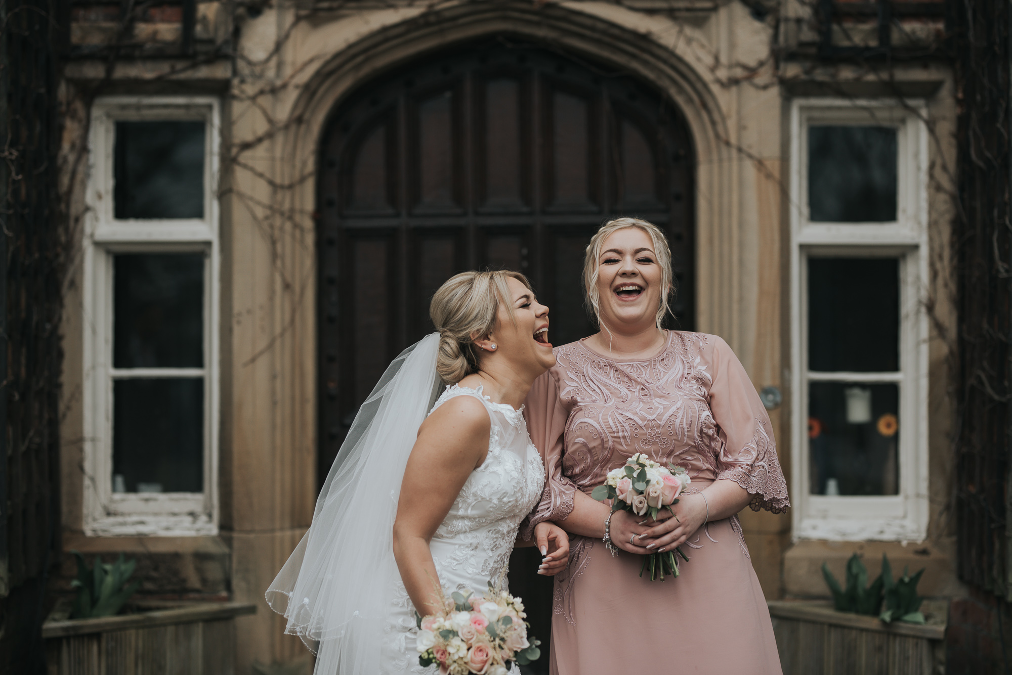 two sisters bride and bridesmaid enjoying some fun on the wedding day