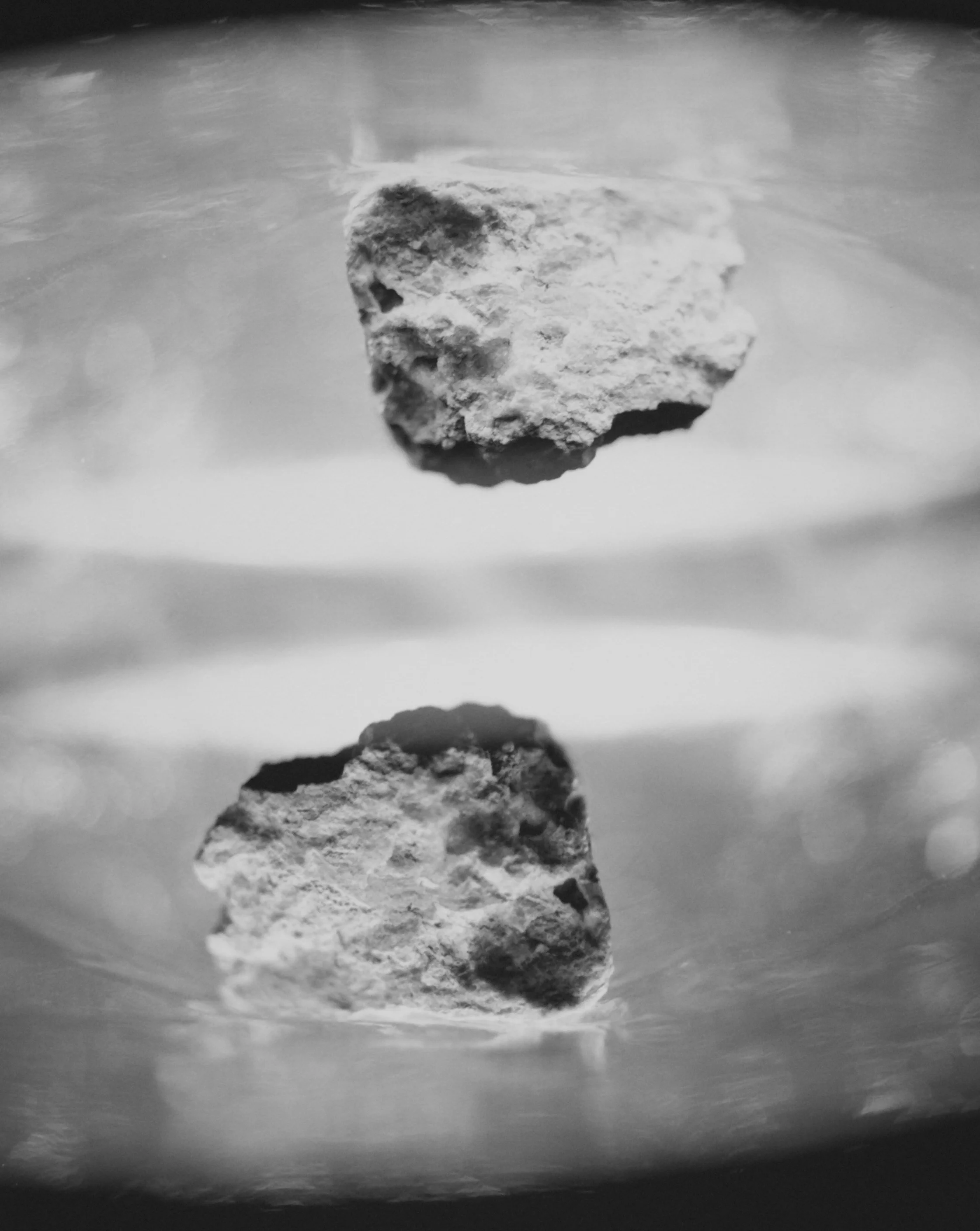 The investigation of the grandeur in photographic truth over the romanticized nostalgia of a sense of place has been an on-going conversation when addressing the history of the American West. I make photographs using four equally sized rocks, a light source, and a camera. Through the limiation of material, I've begun to explore the romantic sublime world of abstract landscapes. What is being seen becomes an illusion by shifting the scale of the natural world to play with perception. My work addresses the duality of the finite within the infinite by challenging the conventions of landscape imagery through abstraction. With the tradtion of making landscape photographs to create a new perspective that mimics yet challenges the reality of what is being seen. The process of viewing an unknown landscape can become a chance to explore, to experience puzzlement and question it's existence, a fictional reality. 