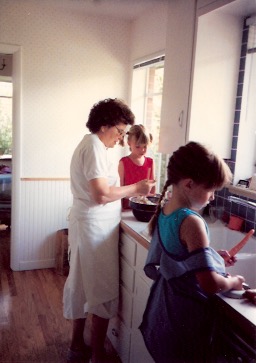 My sister's in the pigtails, I'm in the braid. Whipping up something tasty with Grandma. 1990-something, our kitchen in Denver