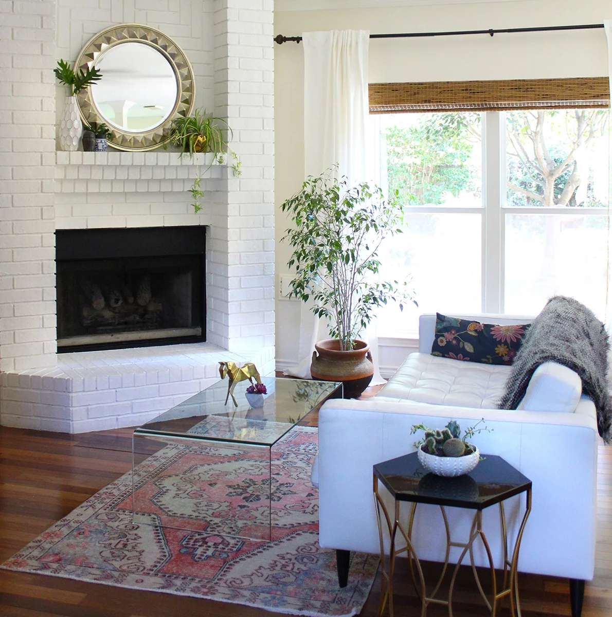  Living room by Kristin Laing Designs featuring painted brick fireplace, vintage Turkish rug and a waterfall coffee table. 