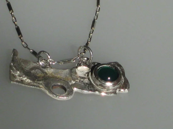 Detail of Silver with green garnet $100.00