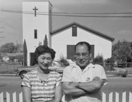 c.1951 ^ Mary & George Sakoguchi in foreground, Mexican Baptist Church at the northwest corner of Allen & King streets