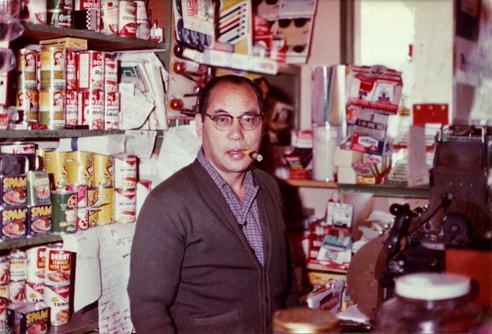 ^ George behind the cash register