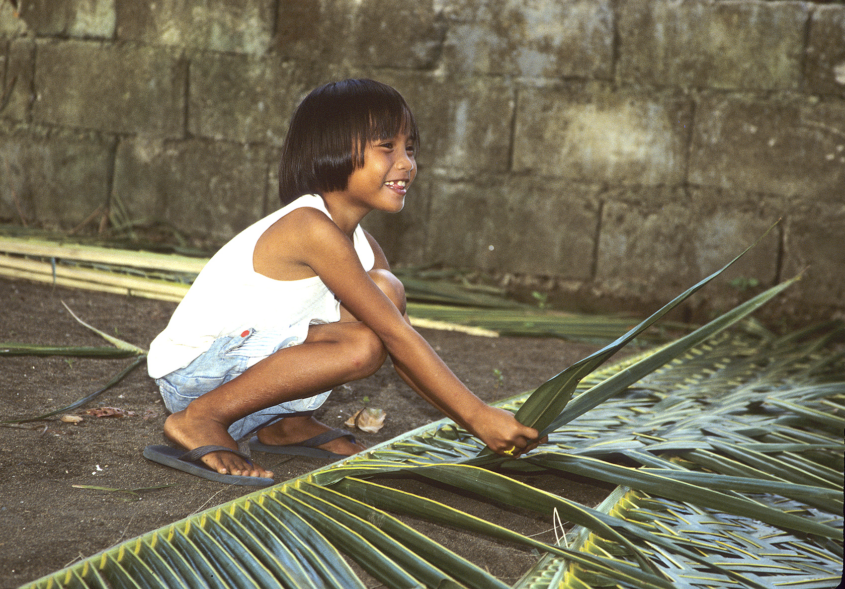 Weaving palm leaves, Philippines