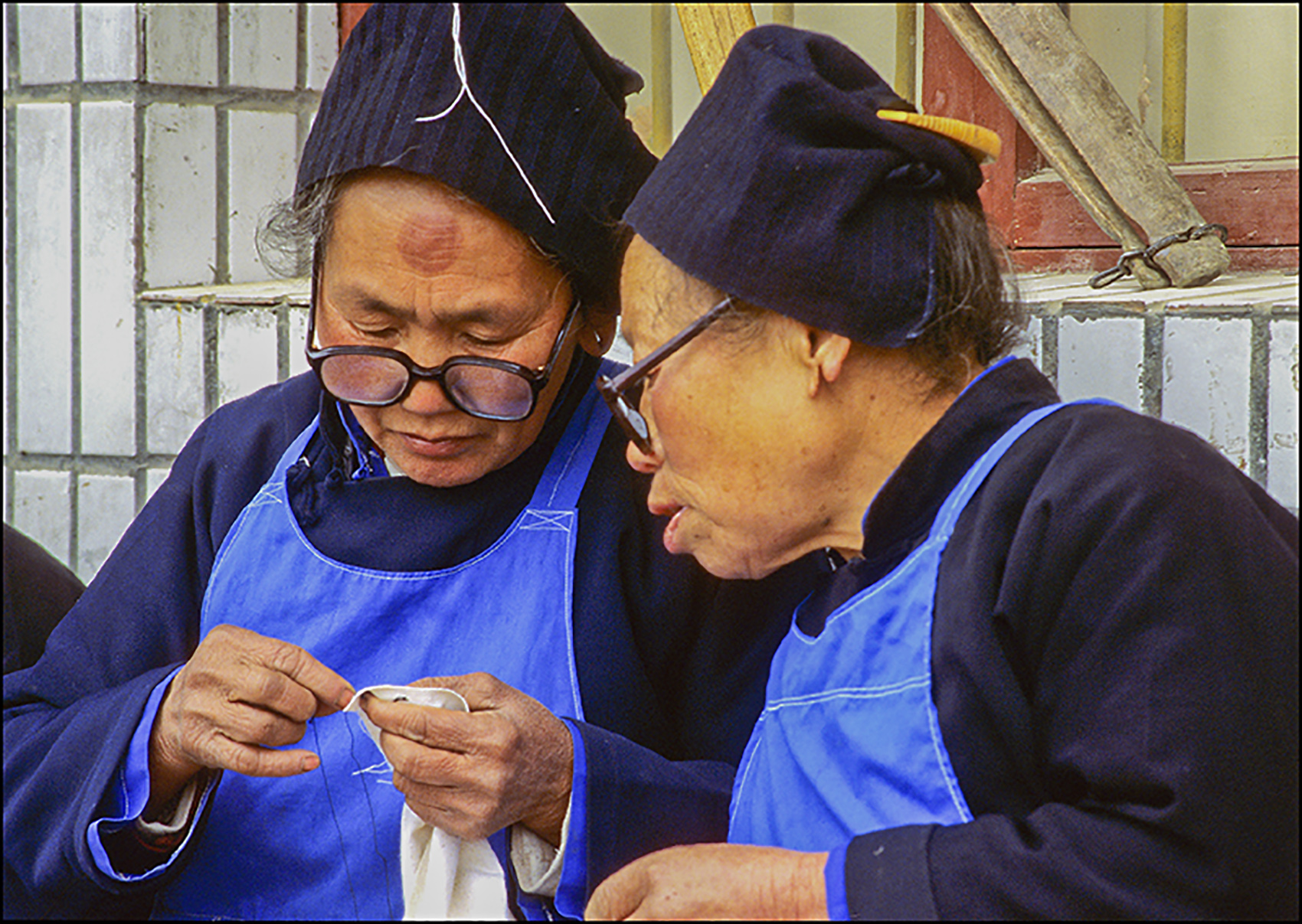 Comparing stitches, Guizhou, China