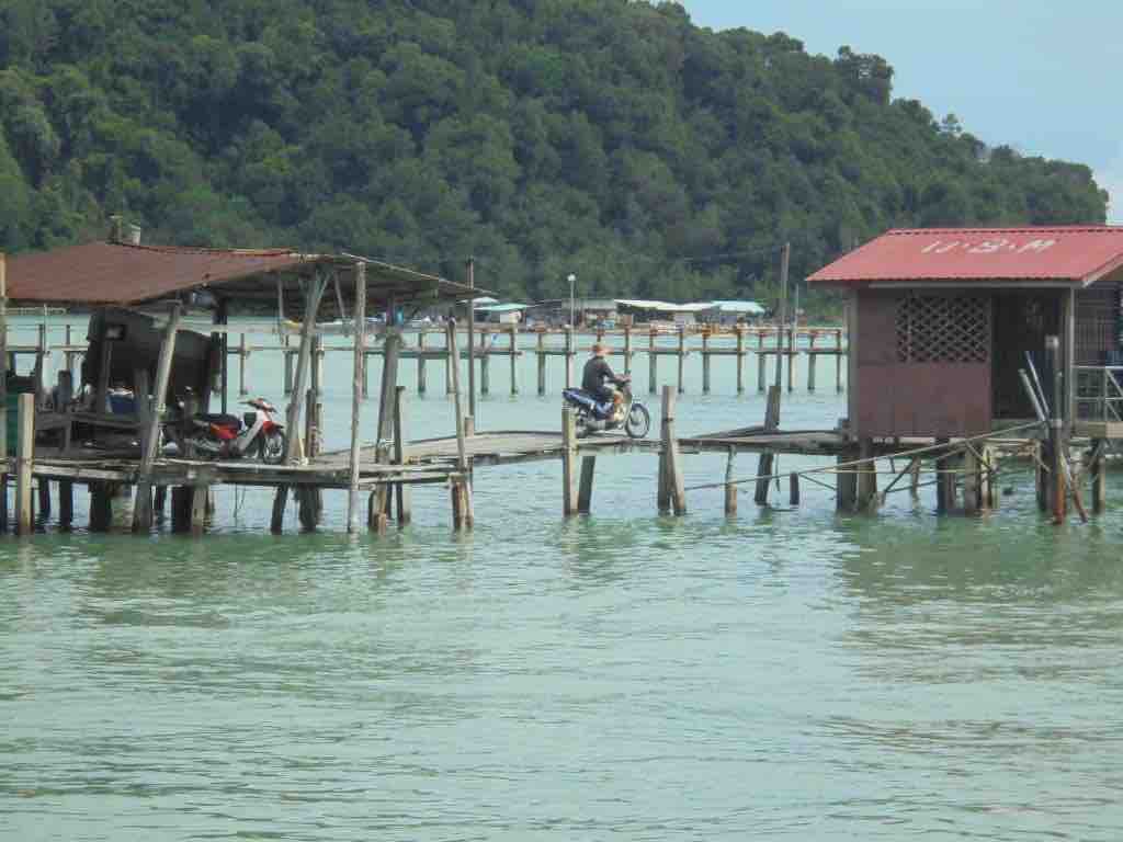 Motorbike on old wooden fishing jetty