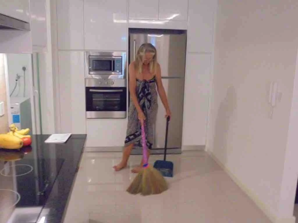 Erica in sarong happily sweeping