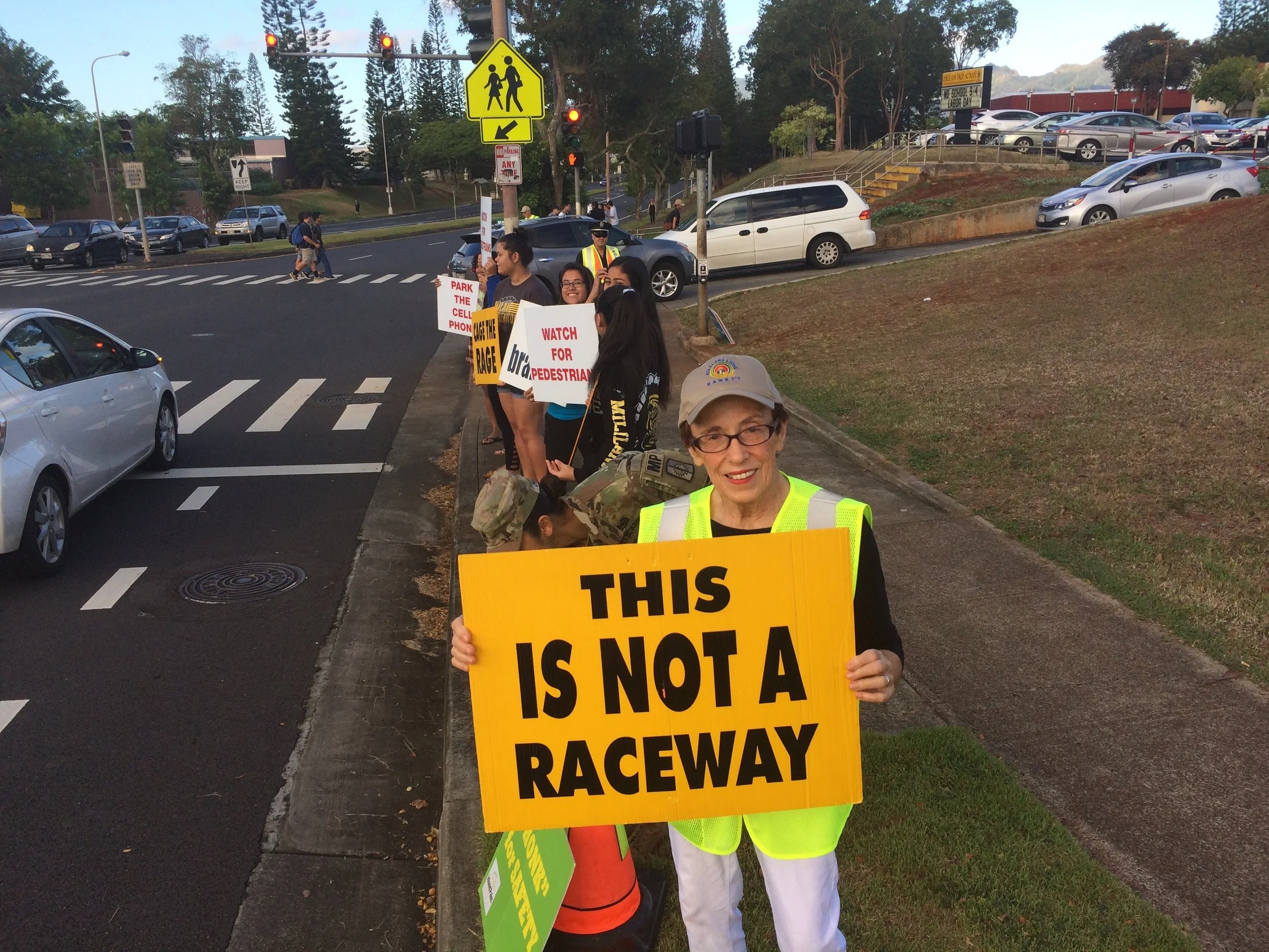 Holding signs on Meheula Parkway to discourage speeding