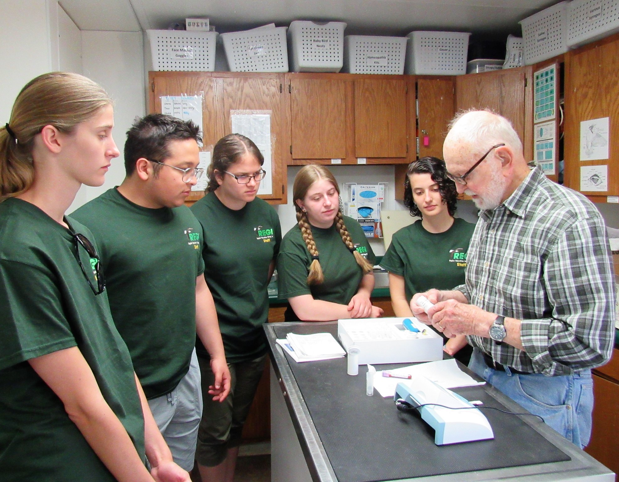 Don Gibson testing the eagles blood for lead poisoning with the interns observing.