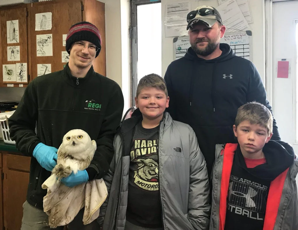 REGI BIOLOGIST GREG RUSS HOLDS CODDINGTON SHORTLY AFTER BRIAN BIADASZ AND HIS SONS, KOLTON AND JAKE, RESCUED THE OWL FROM THEIR BARN. (©RAPTOR EDUCATION GROUP)