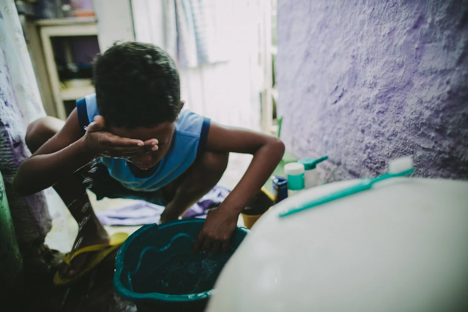 The space where Emidio washes his face in the morning is the same space where the family does all their bathroom, kitchen, and sleeping activities. Emidio's entire house (housing 4 people---soon to be 5) is perhaps no larger than 8 feet by 10 feet. This is Emidio's morning routine before heading to classes at the Compassion Center.