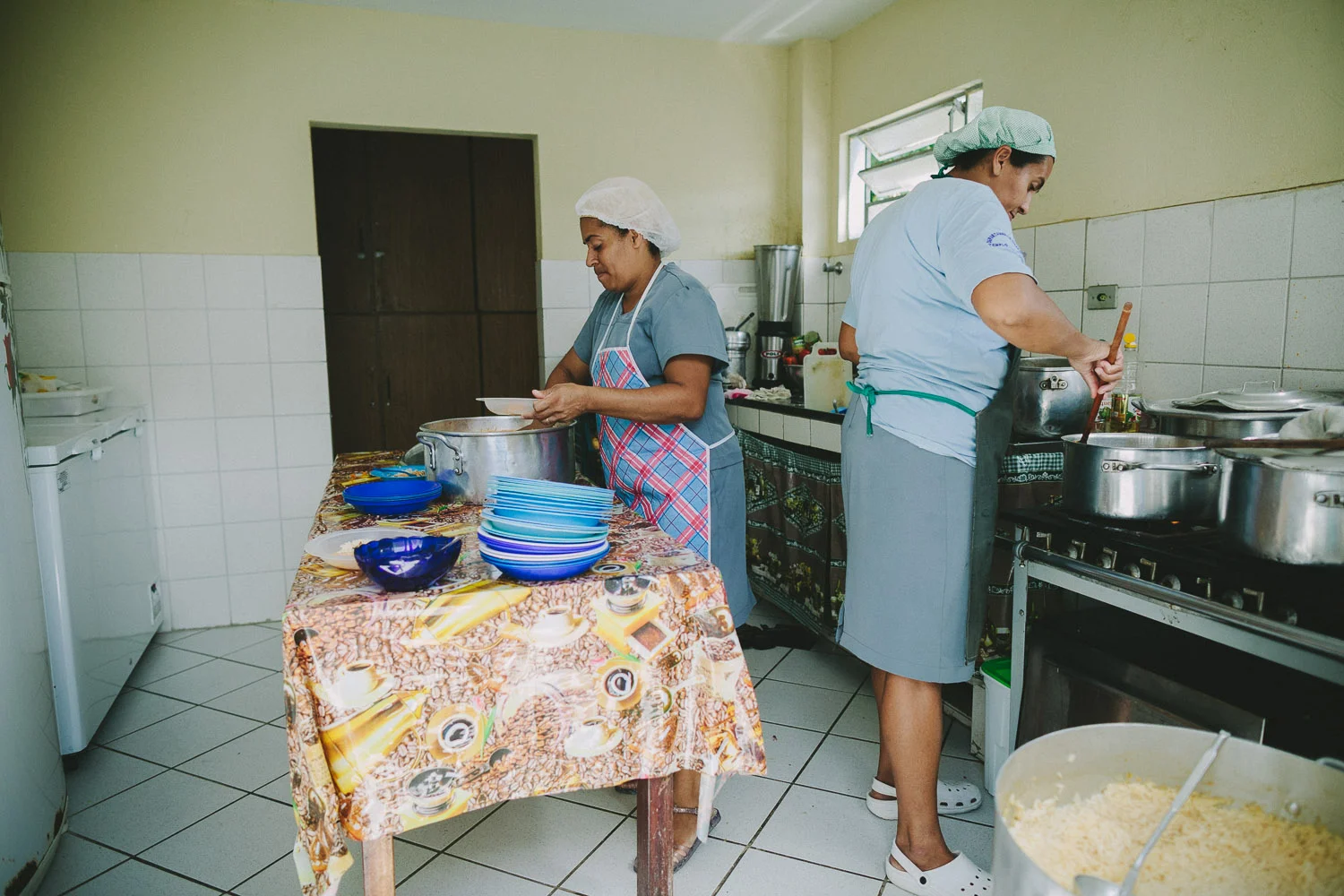 Compassion Center kitchen staff are always busy feeding the children. Eating at the Compassion Center.