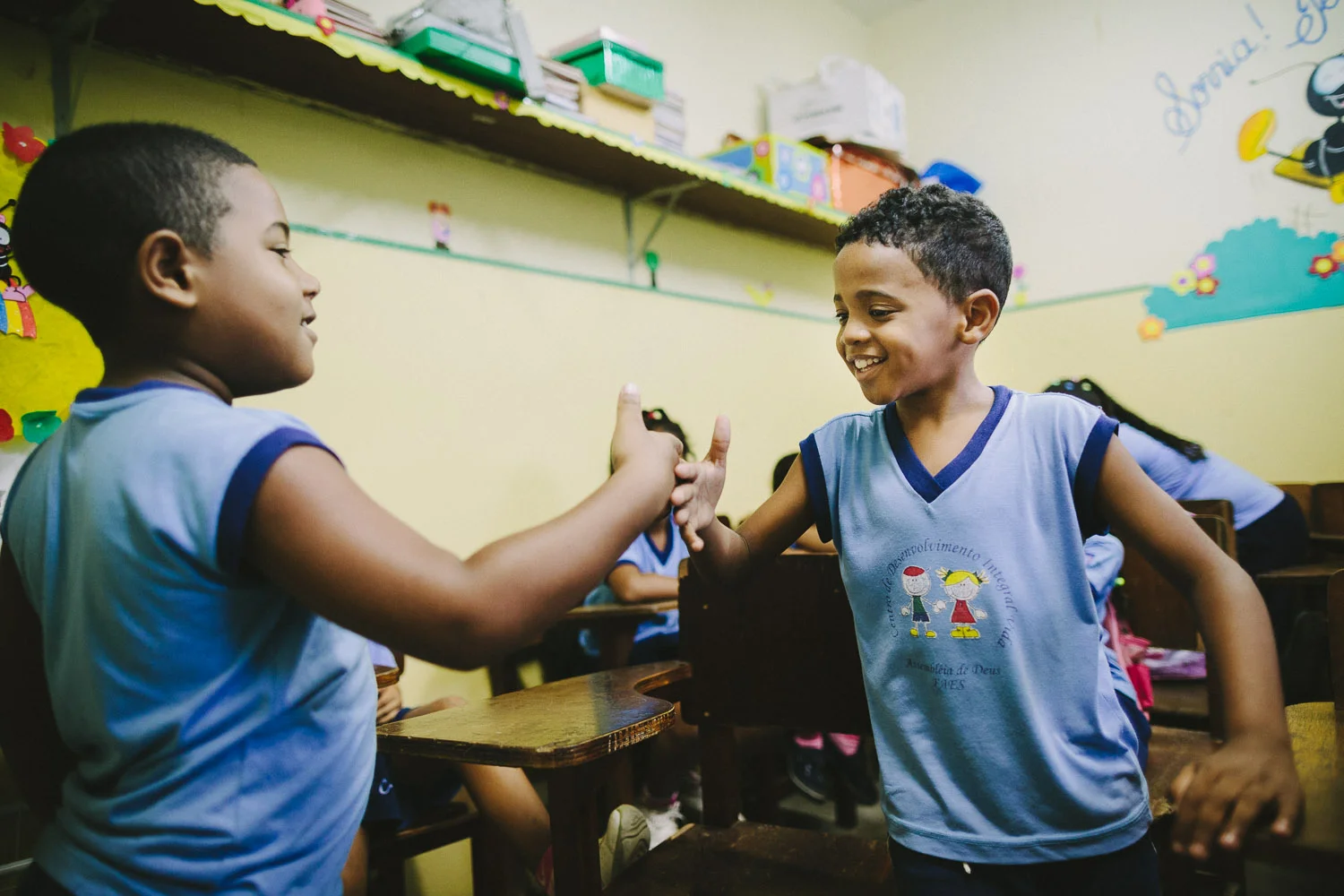 Emidio and his class buddy have several special handshakes that only they do together. Emidio during classes at the Compassion Center.