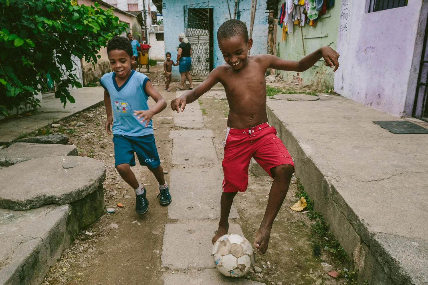 On the way home, Emidio's friend spots him and asks if he wants to pass the ball around while he walks home. Soccer is the most popular sport in Brazil and home to the 2014 World Cup. After his time at the Compassion Center, Emidio walks to his "aunt's" house (family friend---no relation) to be taken care of before heading to school since his mother works until 10pm each night.