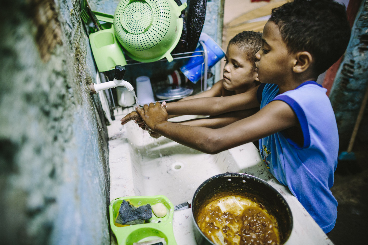   Washing hands before lunch. Each day an "aunt" (family friend--relation) takes care of Emidio and his younger brother between his time at the Compassion Center and School since his mother works until 10pm at night.  