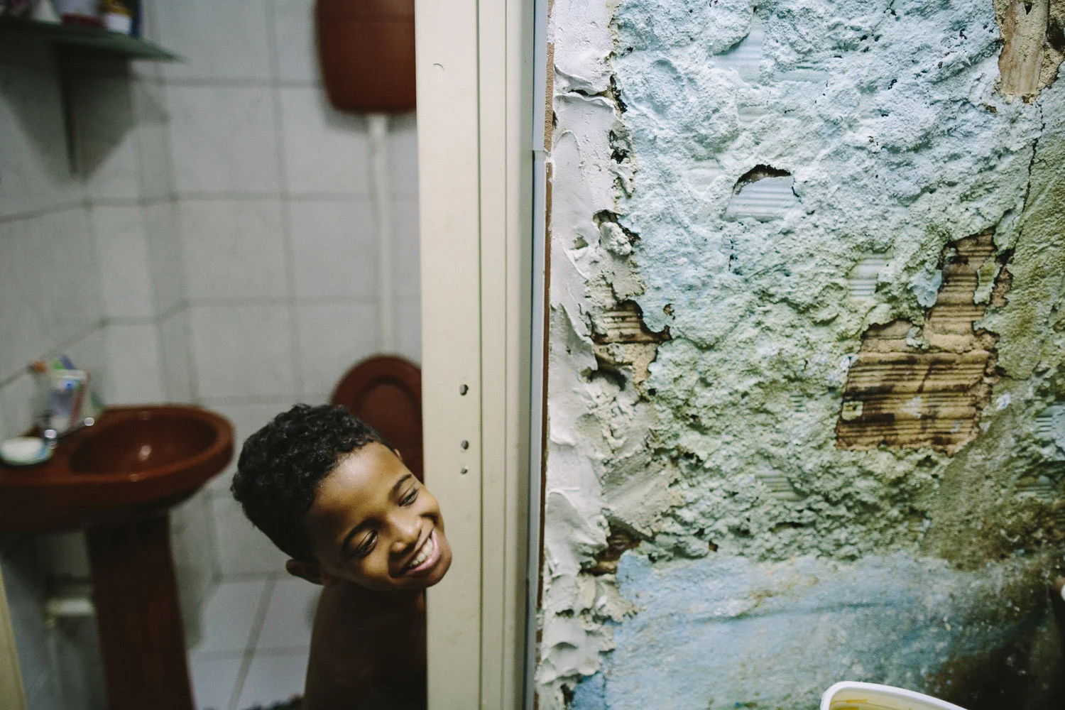 Ever the playful boy, even bathtime is a chance for Emidio to joke around. Each day an "aunt" (family friend--relation) takes care of Emidio and his younger brother between his time at the Compassion Center and School since his mother works until 10pm at night.
