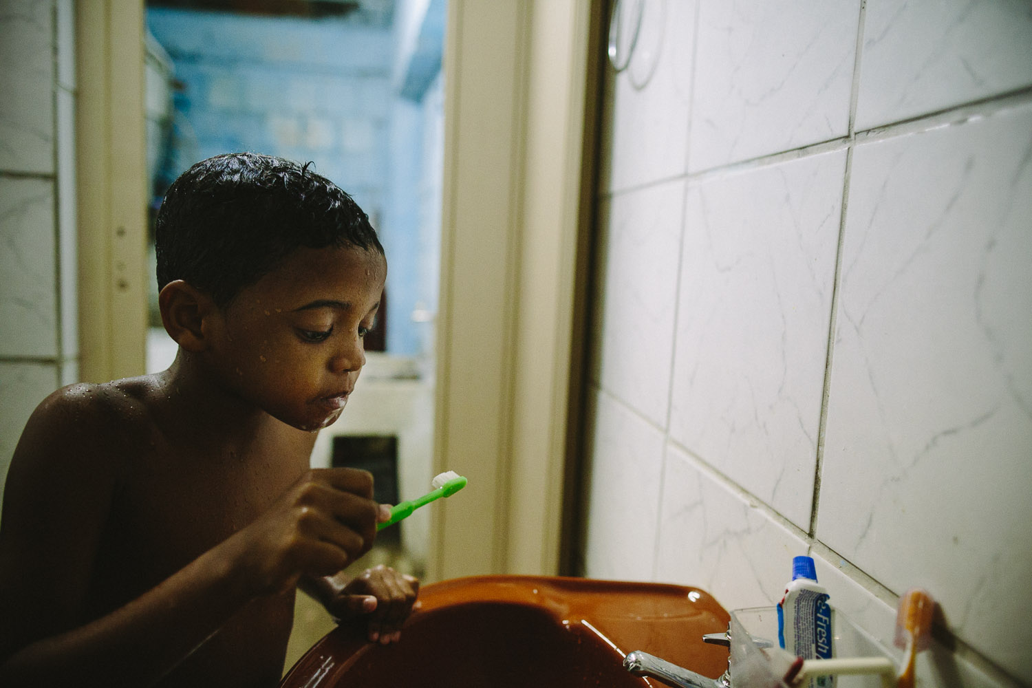   Hygiene is very important to Emidio evidenced by his second teeth bushing of the day. Each day an "aunt" (family friend--relation) takes care of Emidio and his younger brother between his time at the Compassion Center and School since his mother wo
