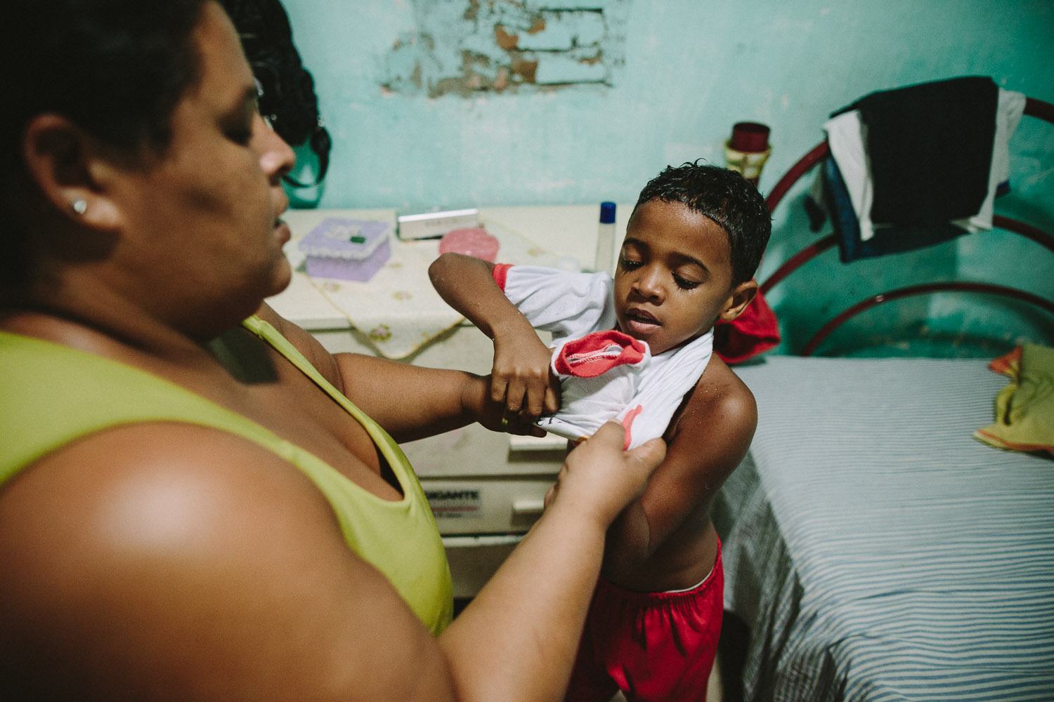   His mother's friend gets Emidio ready for school each day. Each day an "aunt" (family friend--relation) takes care of Emidio and his younger brother between his time at the Compassion Center and School since his mother works until 10pm at night.  