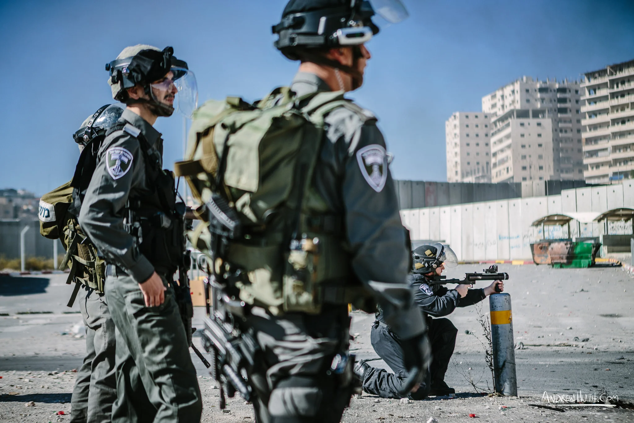 Israeli military using tear gas and guns in an armed conflict with the residents of Shu'afat Refugee Camp. Palestinian youth clash with Israeli military in Shu'afat Refugee Camp in East Jerusalem on Friday, November 7, 2014. The recent, but temporarily total closure of one of Muslim's holiest sites, the Al-Aqsa Mosque, (the first since 1967) and the subsequent limited access for many Muslims to the mosque since has raised tension between Israeli's military and the Arab community.