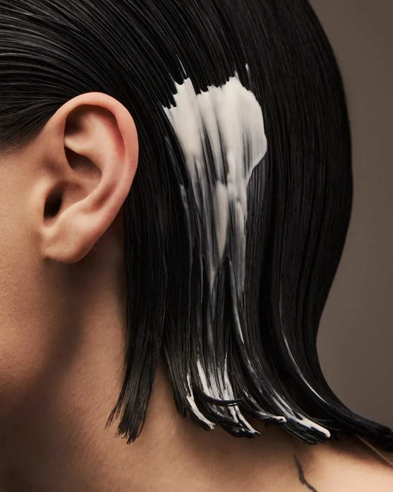 Professional scalp and hair treatment mask applied to glossy dark hair at Murphy Gozzard, best salon Paddington