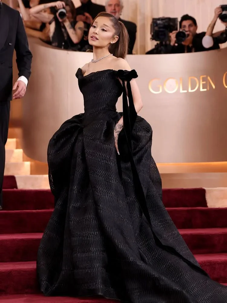 Ariana Grande showcasing a sleek high ponytail with high-shine finish at the Golden Globes red carpet.