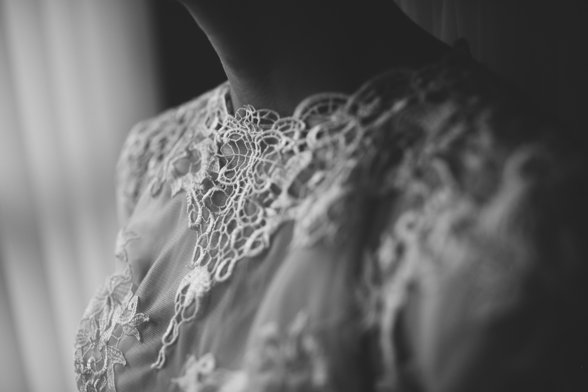 Close-up of a lace collar on a woman’s dress, black and white photo.